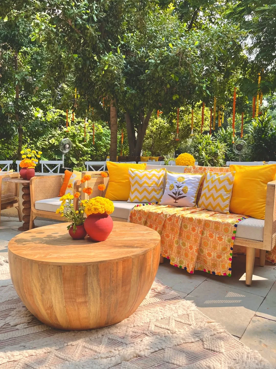 Cane lounge seating styled with marigold cushions at a haldi ceremony in Manesar