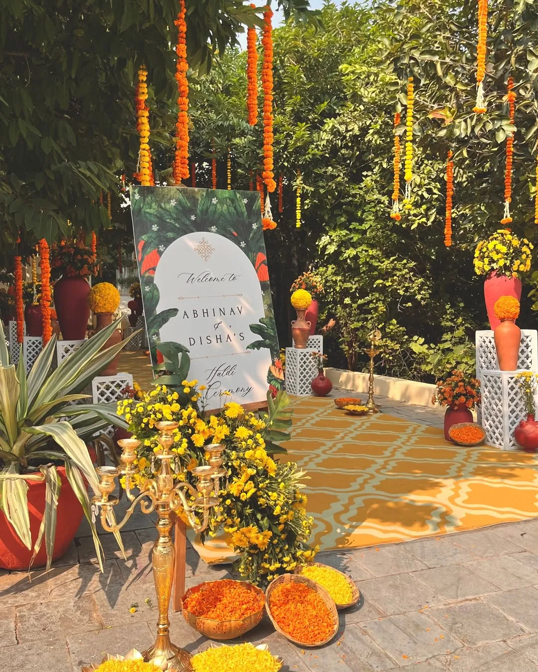 Marigold-draped haldi ceremony welcome sign for Abhinav and Disha's wedding in Manesar, planned by Saffron Collective