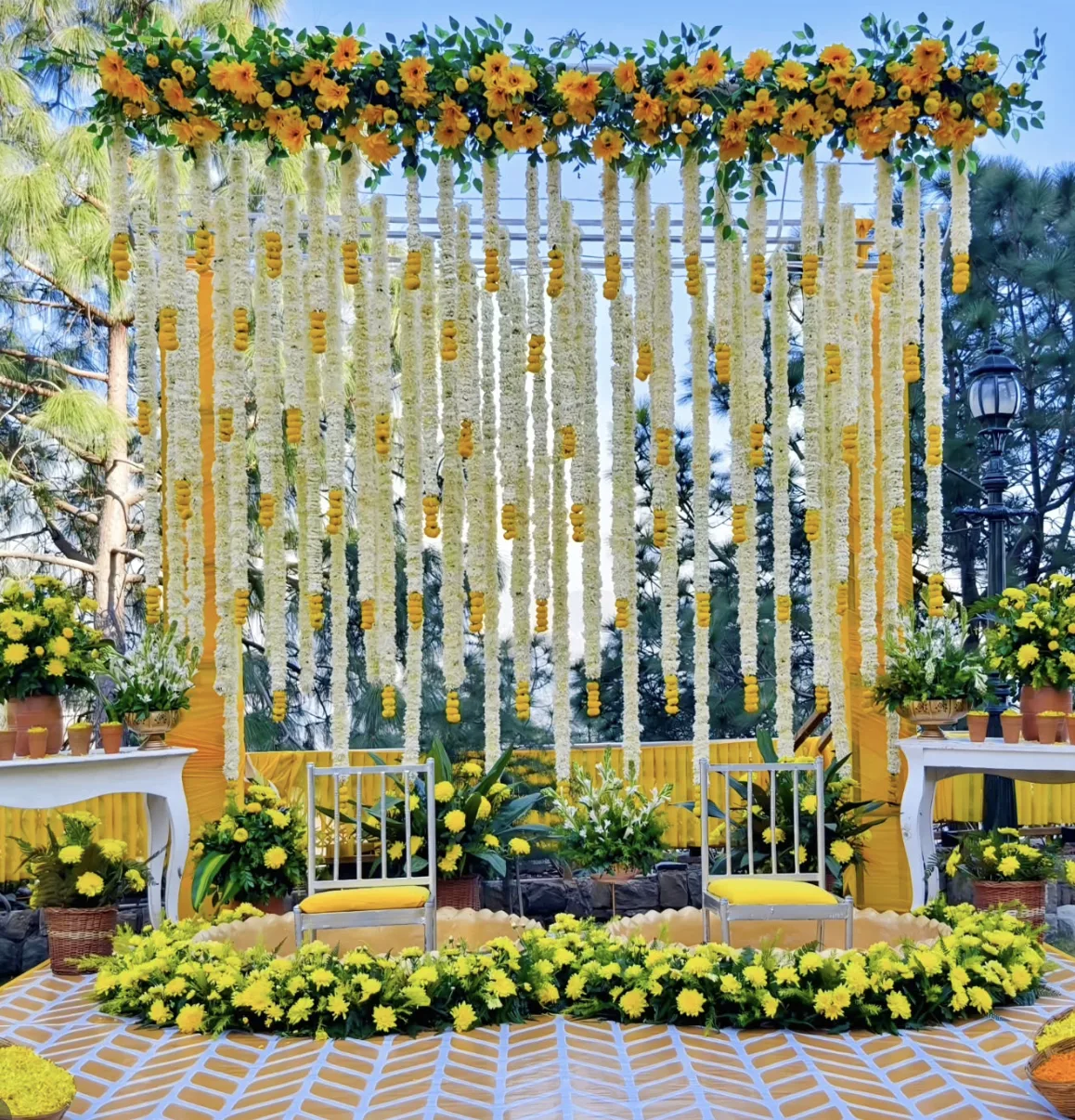 Yellow marigold and chrysanthemum haldi mandap at an intimate wedding in Kasauli